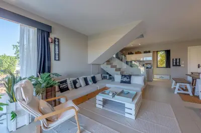 a living room with white furniture and a staircase at Ultimate Beachstyle Getaway Gouna 2BR Twinhouse. BBQ, Lagoon & Pool Access in Hurghada