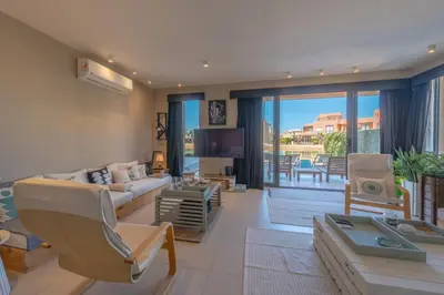 a living room with a couch and a table at Ultimate Beachstyle Getaway Gouna 2BR Twinhouse. BBQ, Lagoon & Pool Access in Hurghada