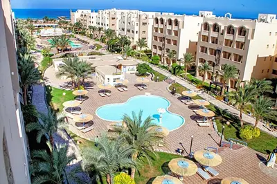 an aerial view of a resort with a pool and umbrellas at Private 3 bdrm apartment at ElKarma Aqua Beach Reaort in Hurghada
