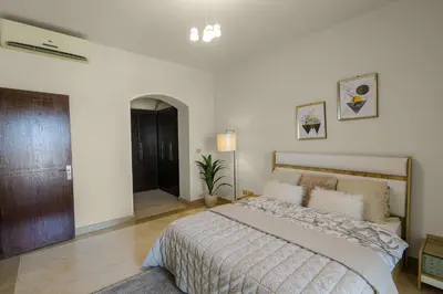 a bedroom with a large bed in a room at Azzurra Sahl Haseesh in Hurghada