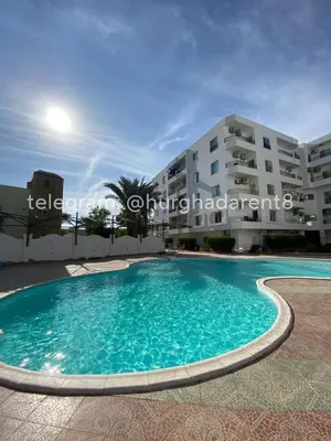 a swimming pool in front of a building at Makramia Compound in Hurghada