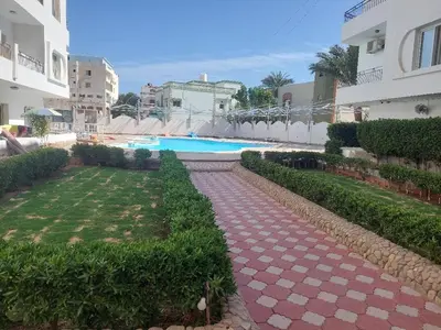 a pathway leading to a swimming pool in a building at Makramia Compound in Hurghada