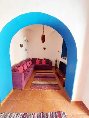 a living room with a couch and an archway at Villa Cleopatra Luxor west bank in Luxor