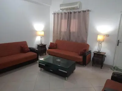 a living room with two couches and a table at Abo Hisham Nile Flat in Luxor