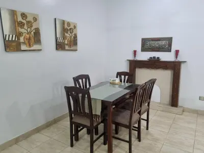a dining room with a table and chairs and a fireplace at Abo Hisham Nile Flat in Luxor