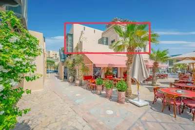 a street with tables and chairs and a mirror at SeaView Penthouse with Roof in Marina El Gouna Egypt (Center) in Hurghada
