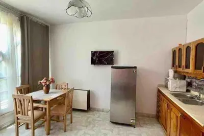 a kitchen with a table and a stainless steel refrigerator at Villa 2 apartment 4 village veiw infront of Palma de Meritee in Hurghada