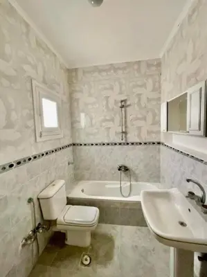 a bathroom with a toilet and a tub and a sink at Villa 2 apartament 3 sea view infront of Palma de Meritee in Hurghada