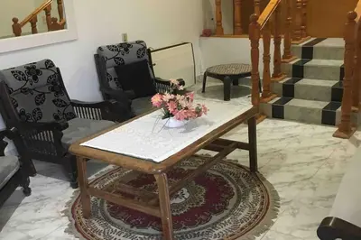 a living room with a table with flowers on it at Villa 2 apartment 2 village veiw infront of Palma de Meritee in Hurghada