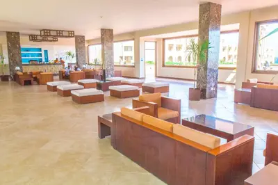 a lobby with couches and tables in a building at Viva Blue Resort and Diving Sharm El Naga (Adults Only) in Hurghada