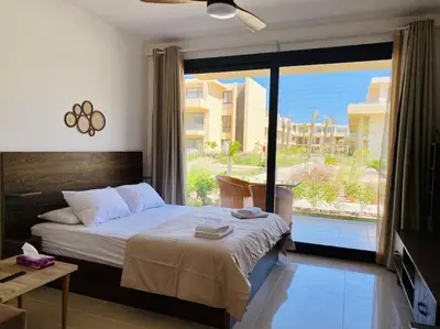 a bedroom with a bed and a large window at A Bright Studio @GCribs - El Gouna W/ Shared pool! in El Gouna