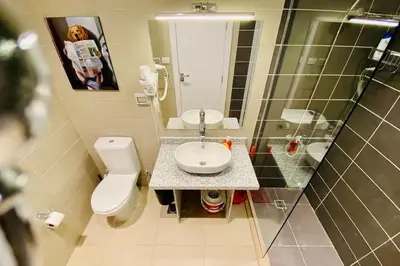 a bathroom with a toilet and a sink and a mirror at A Bright Studio @GCribs - El Gouna W/ Shared pool! in El Gouna