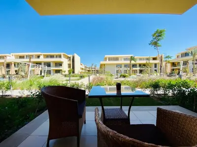 a patio with a table and chairs and a building at A Bright Studio @GCribs - El Gouna W/ Shared pool! in El Gouna