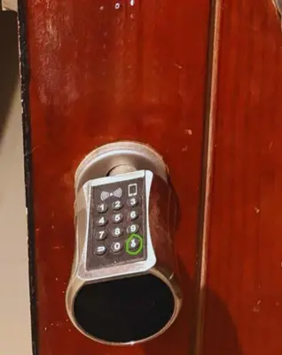 a remote control sticking out of a wooden door at Cozy, Calm, Studio in Veranda Sahl Hasheesh Resort in Hurghada