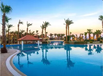 a pool at a resort with palm trees at Cozy, Calm, Studio in Veranda Sahl Hasheesh Resort in Hurghada