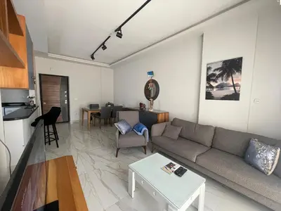 a living room with a couch and a table at Modern HOME DownTown in Hurghada
