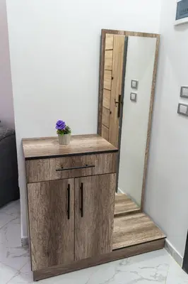a wooden dresser with a mirror on top at Juliana Beach Hurghada in Hurghada