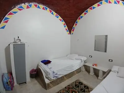 a room with two archways with a bed in it at Ezzo Nubian guest house in Aswan