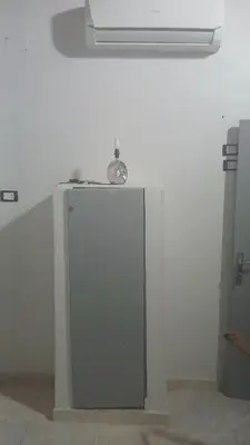 a white refrigerator in a room with a fan at Ezzo Nubian guest house in Aswan