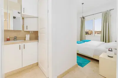 a kitchen and a bedroom with a bed and a bathroom at Wonderful apartment with prime location & pool in Hurghada