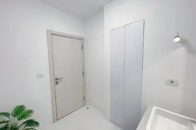 a white bathroom with a shower and a sink at Charming & Beautifully Styled 3BDR Swan Lake Gouna in Hurghada