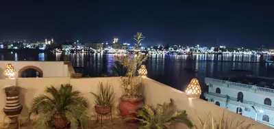a view of a harbor at night with boats in the water at Elminaa Residence 6 in Luxor