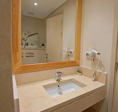 a bathroom with a sink and a large mirror at Ollystays Mangroovy 1 BR Beach and Pool Free access in Hurghada