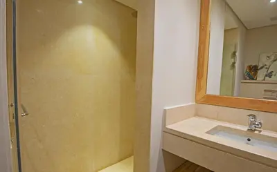 a bathroom with a shower and a sink and a mirror at Ollystays Mangroovy 1 BR Beach and Pool Free access in Hurghada
