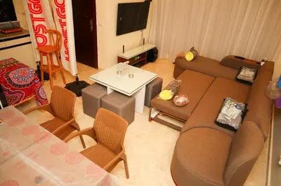 a living room with a couch and chairs and a table at Hostgool Beach Chalets Mirage bay resort & aqua park in Hurghada