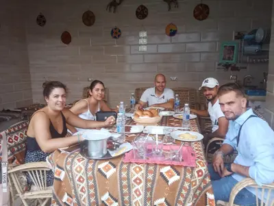 a group of people sitting around a table at Bakar House in Aswan
