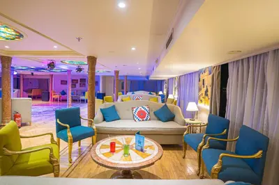 a living room with a couch and a table and chairs at 5 Days / 4 Nights Cruise Trip from Luxor to Aswan With all Visits Every Saturday, Monday and Thursday in Luxor