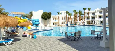 a pool at a resort with a water slide at Mirage Aqua Resort 2 Bedroom Apartment in Hurghada