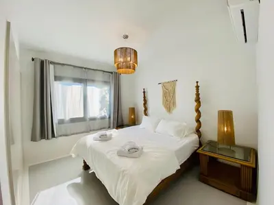 a bedroom with a bed with two towels on it at Ground Spacious 1-BR Apt @ SwanLake El Gouna ! in Hurghada