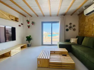 a living room with a green couch and a table at Rustic 1 BR-Apt@ Swanlake El Gouna ! in Hurghada