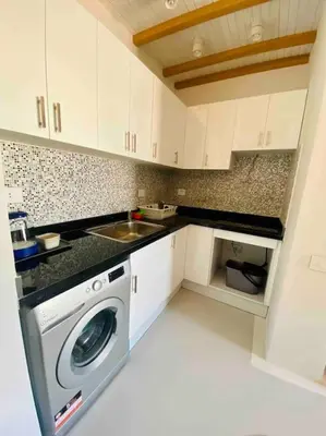 a kitchen with a washing machine and a sink at Rustic 1 BR-Apt@ Swanlake El Gouna ! in Hurghada