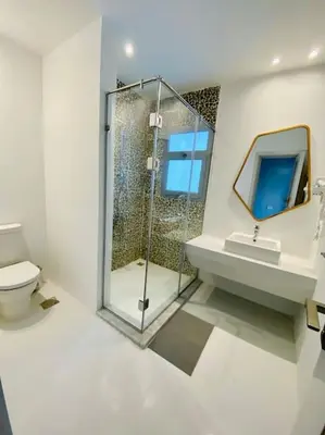 a bathroom with a shower and a toilet and a sink at Rustic 1 BR-Apt@ Swanlake El Gouna ! in Hurghada