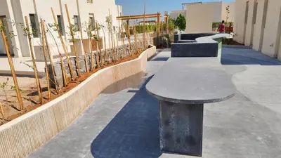 a bench sitting on a sidewalk next to a building at Shedwan 3 bed and nanny room townhouse in Hurghada