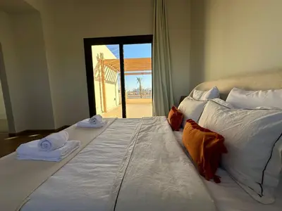 a large bed in a room with towels on it at Shedwan 3 bed and nanny room townhouse in Hurghada