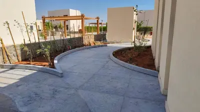 a walkway leading to a building with plants at Shedwan 3 bed and nanny room townhouse in Hurghada