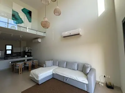 a living room with a couch and a kitchen at Shedwan 3 bed and nanny room townhouse in Hurghada
