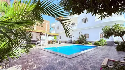 a courtyard with a swimming pool and a building at Panorama Hotel in Luxor
