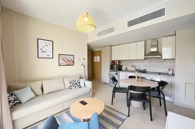 a living room with a couch and a table at Smooth & Snug 1 BDR Mangroovy Free Beach & Pool Access in Hurghada