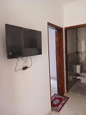 a flat screen tv hanging on a wall at Sky Guest House in Luxor