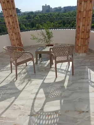 two chairs and a table on a patio with a view at Sky Guest House in Luxor