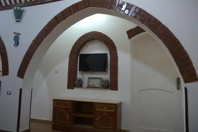 an archway with a tv on a wall at Mogran Guest House in Luxor