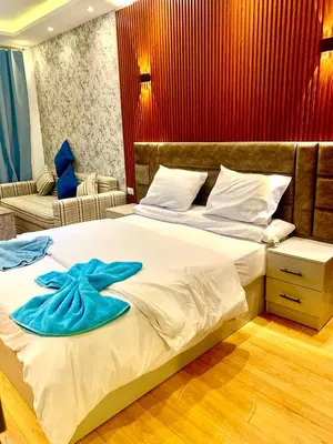 a bedroom with a large bed with a blue towel on it at Sunny studio with 3 swimming pools Florenza Hurghada in Hurghada