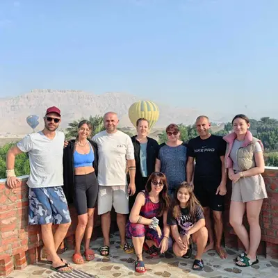 a group of people posing for a picture on a wall at Karima House in Luxor