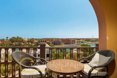 a patio with a table and chairs on a balcony at 2-BR Penthouse with roof terrace in Abu Tig Marina in Hurghada