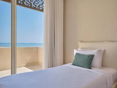 a bedroom with a bed with a view of the ocean at Boutique Residence Mangroovy-Lemon Spaces Gouna in Hurghada