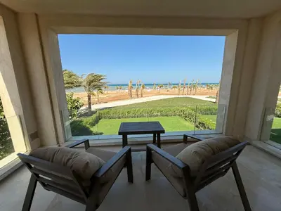 a room with two chairs and a table and a large window at Boutique Residence Mangroovy-Lemon Spaces Gouna in Hurghada